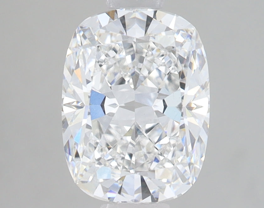 Cushion-cut lab-grown diamond with faceted surface showing light refraction and sparkle against neutral background.