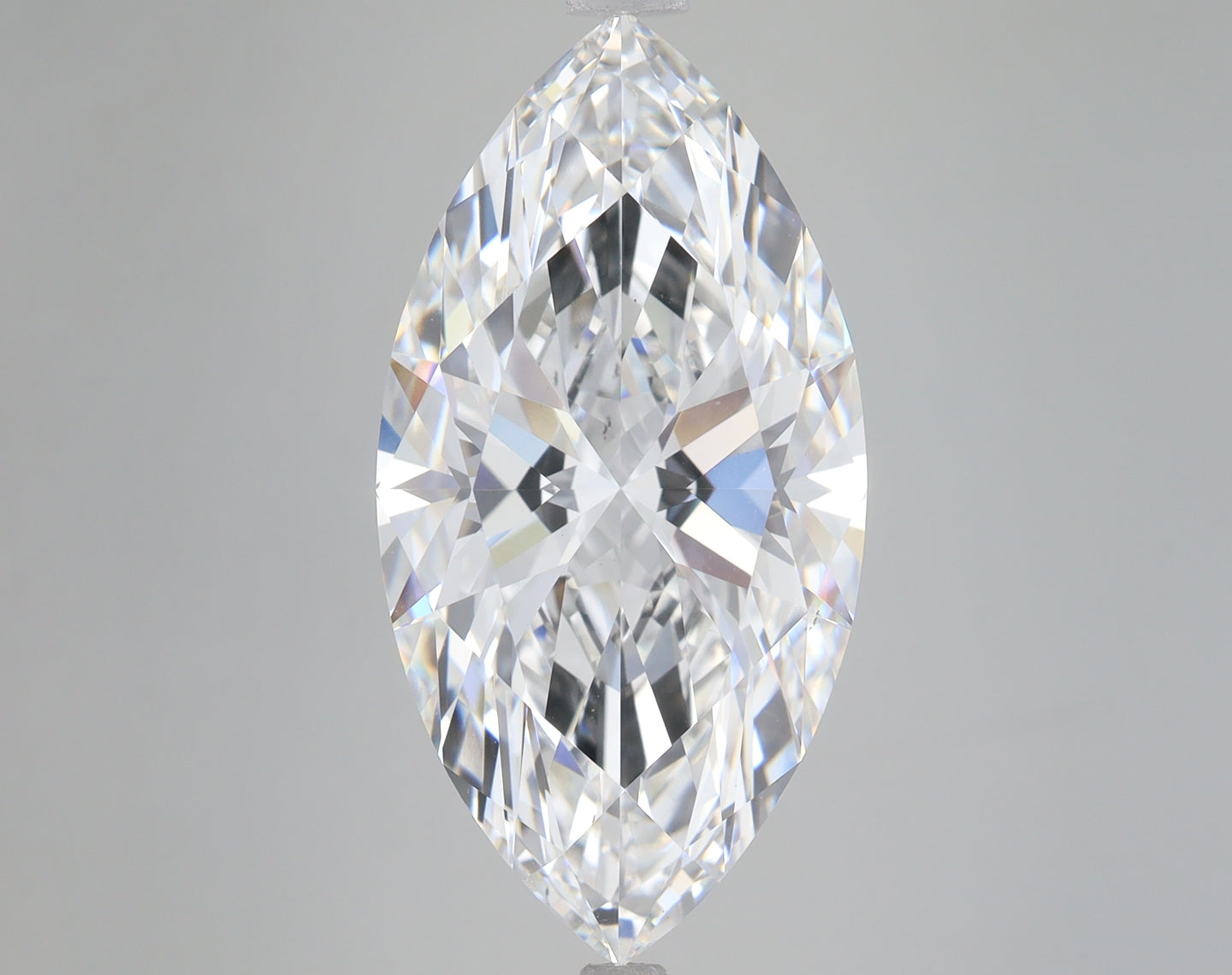 Marquise-cut colorless diamond with faceted surface reflecting light, displayed against neutral gray background.