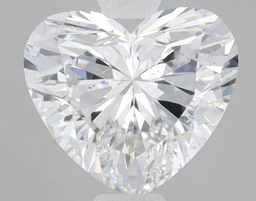 Heart-shaped colorless diamond with brilliant faceting and light reflections on gray background.