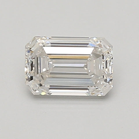 Emerald-cut lab-grown diamond with faceted sides and stepped crown, displaying clear facets and light refraction on neutral b