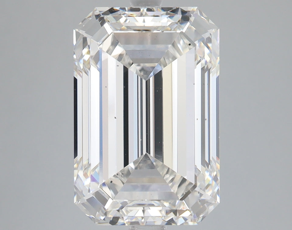 Emerald-cut lab-grown diamond with clear facets and light reflections on neutral background.