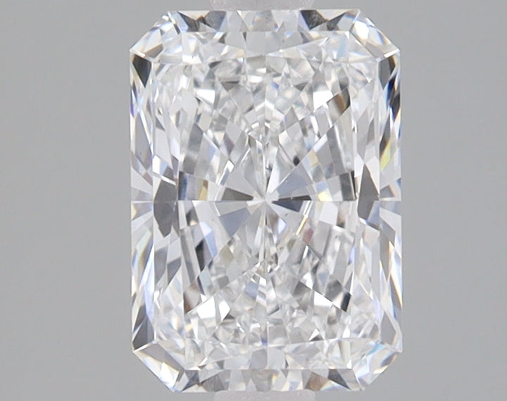 Radiant cut loose diamond with clear faceting and light reflection on neutral gray background.