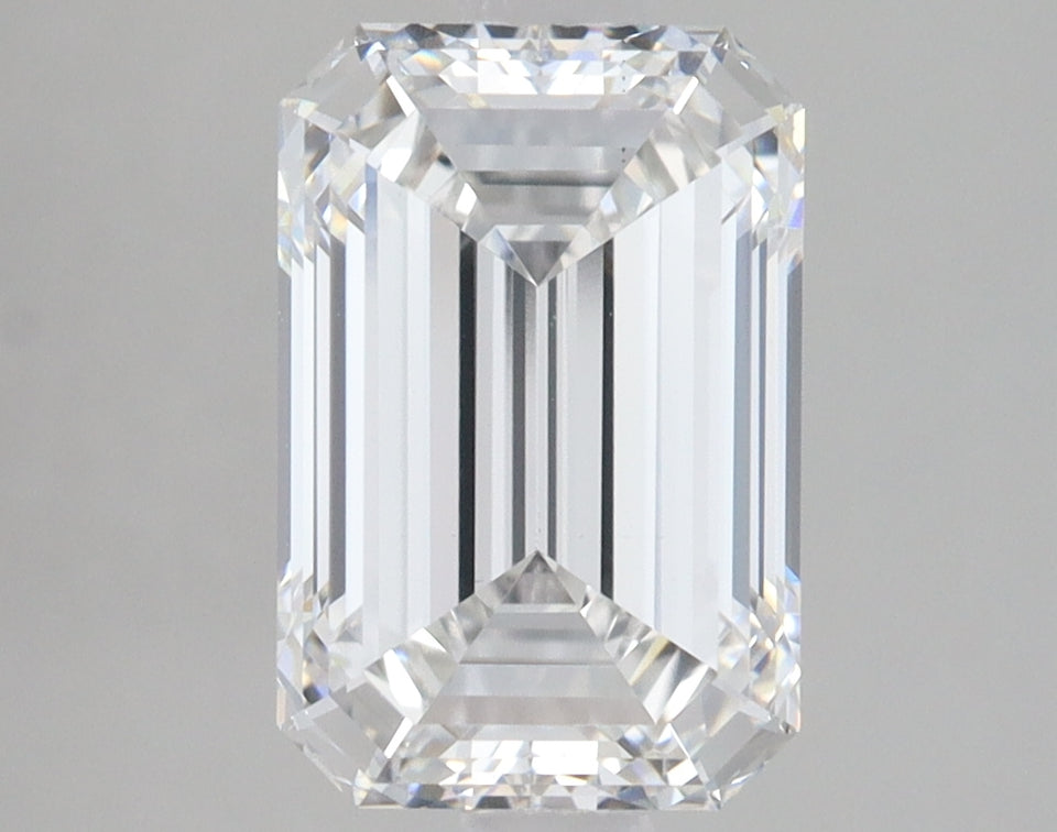 Clear emerald-cut lab-grown diamond with faceted edges and light reflections on neutral background.