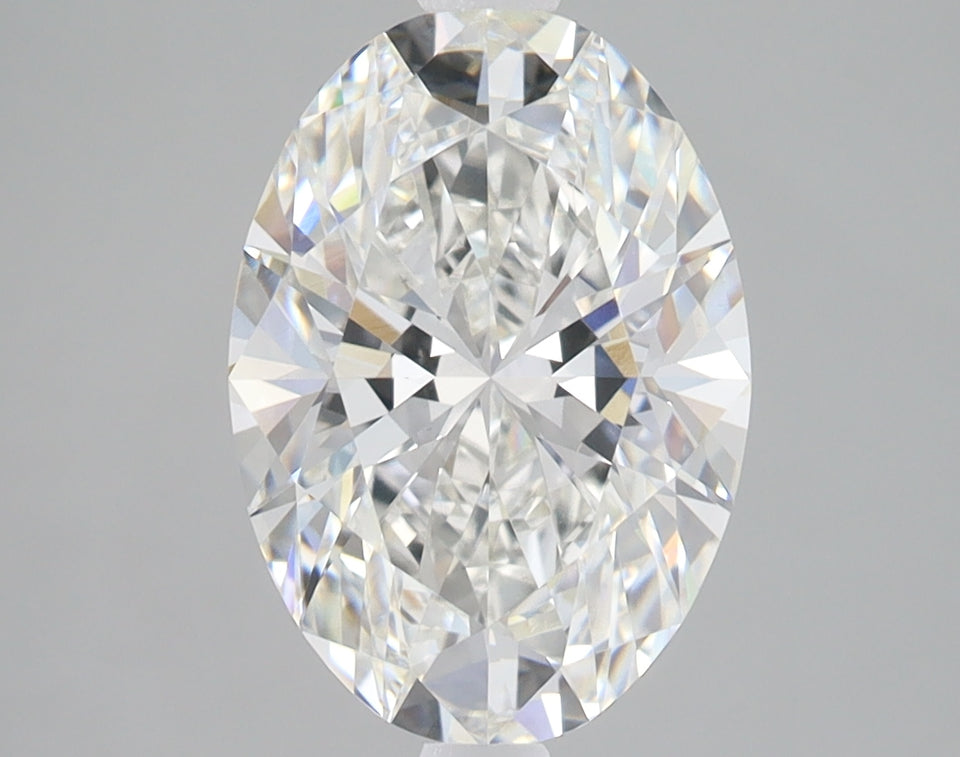 Clear oval-cut diamond with faceted surfaces reflecting light, displayed against a neutral gray background.