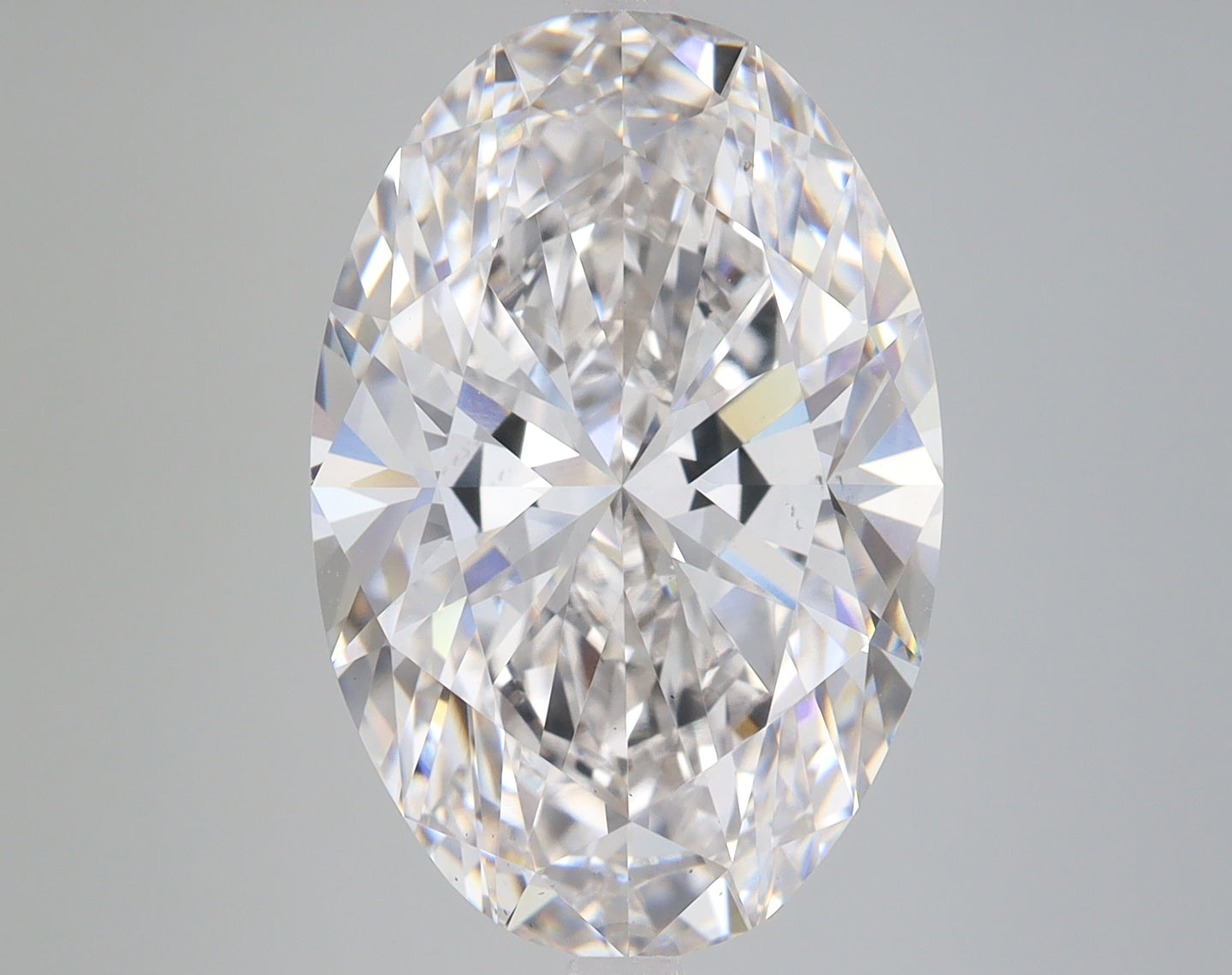 Oval-cut lab-grown diamond with faceted surface, displaying light refraction and sparkle against neutral background.