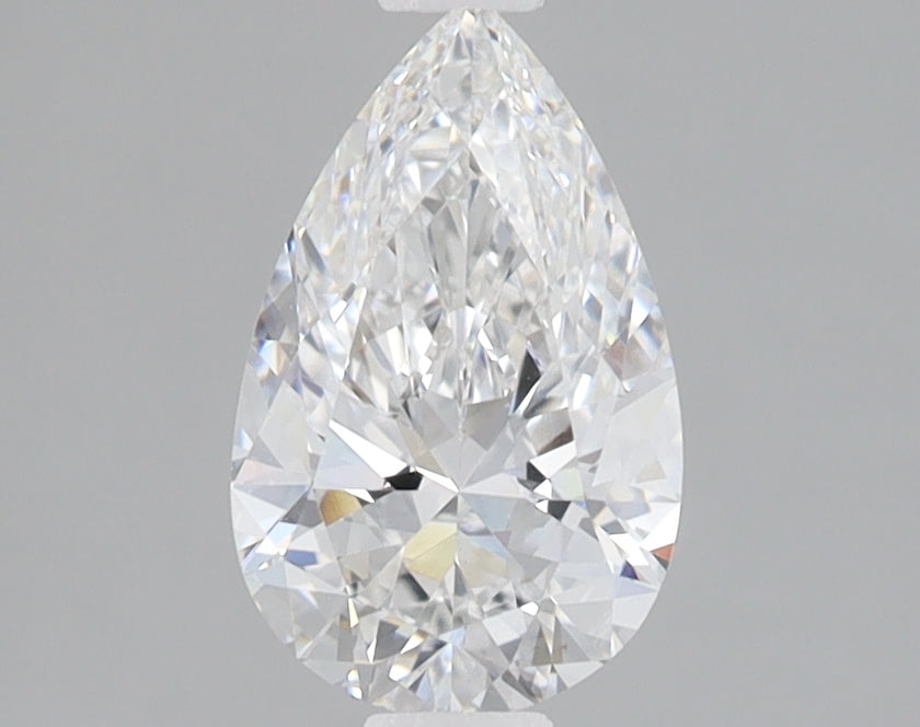 Pear-shaped colorless lab-grown diamond with faceted surfaces and bright light refraction on gray background.