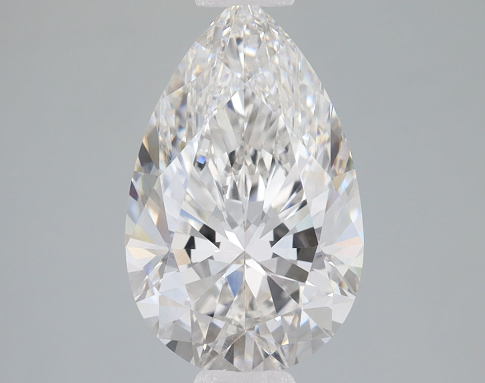 Pear-shaped faceted lab-grown diamond with brilliant clarity and light refraction on gray background.