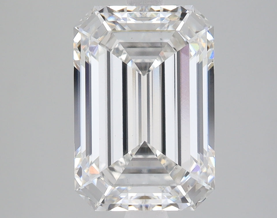 Emerald-cut lab-grown diamond with clear facets and light refraction on gray background.
