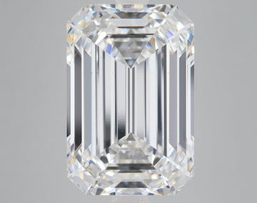 Clear emerald-cut diamond with faceted surfaces and light refraction on neutral gray background.