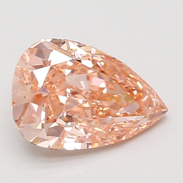 Pear-shaped lab-grown diamond with faceted surface and light peachy-pink tone on neutral background.