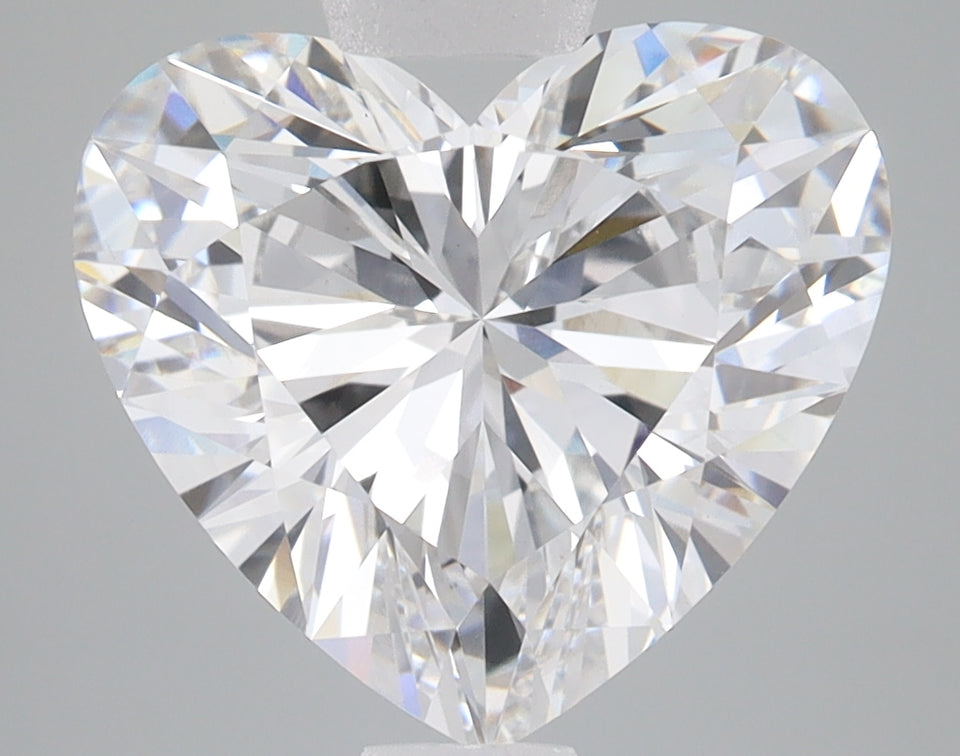 Heart-shaped lab-grown diamond with brilliant faceting and clear coloring on gray background.