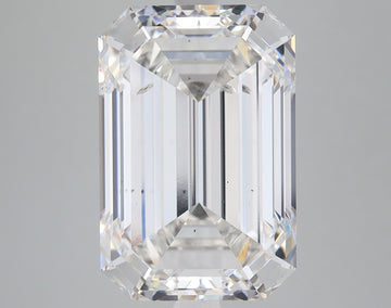 Emerald-cut lab-grown diamond with faceted edges and clear transparency, displayed against neutral gray background.
