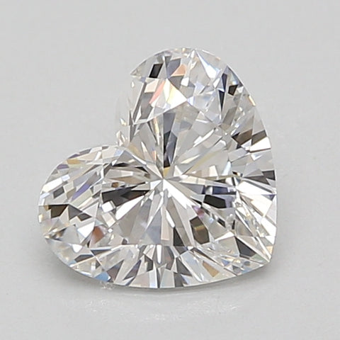 Heart-shaped faceted lab-grown diamond with brilliant light reflections on neutral background.