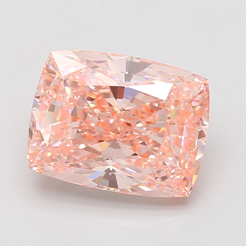 Cushion cut lab-grown diamond with light pink hue, displaying faceted surfaces and light reflections.
