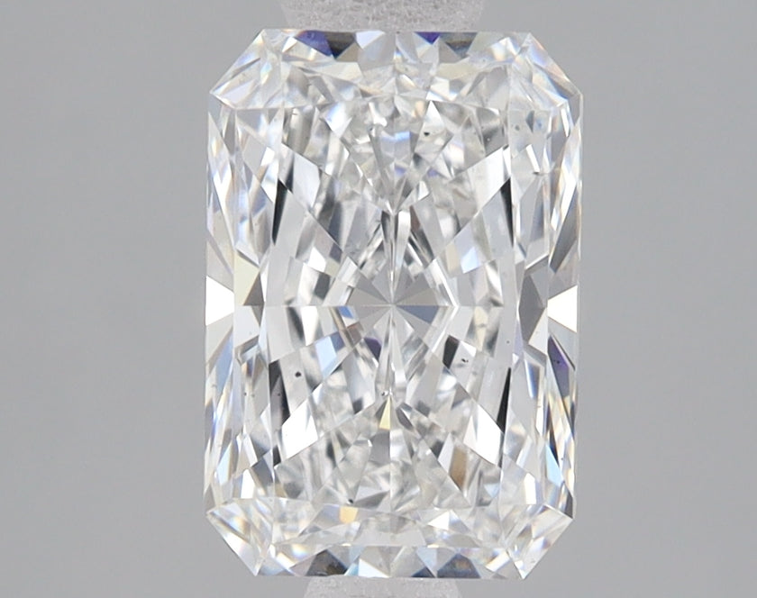 Radiant cut loose diamond with faceted surfaces reflecting light, displayed against gray background.