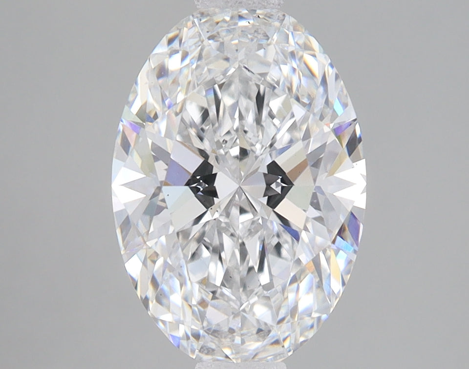 Oval-cut lab-grown diamond with faceted surfaces reflecting light, displayed against a neutral gray background.