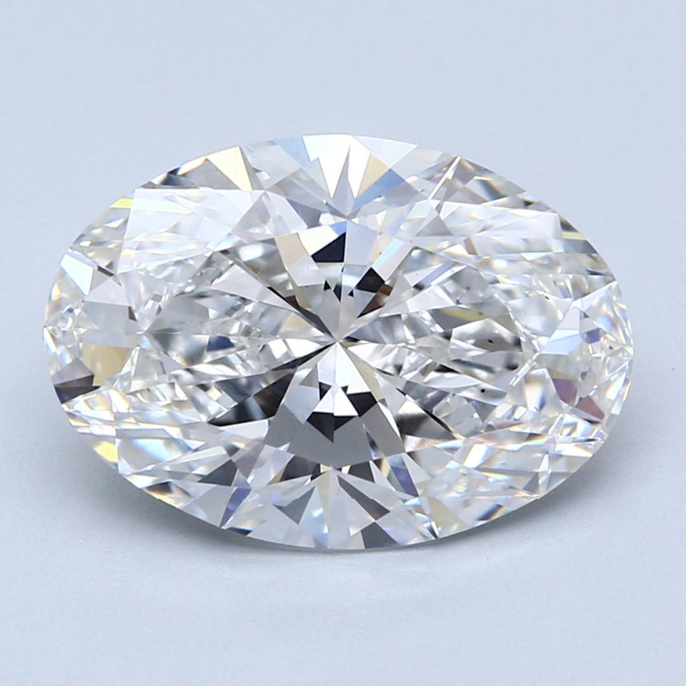 Oval-cut lab-grown diamond with faceted surfaces and light refraction on light blue background.