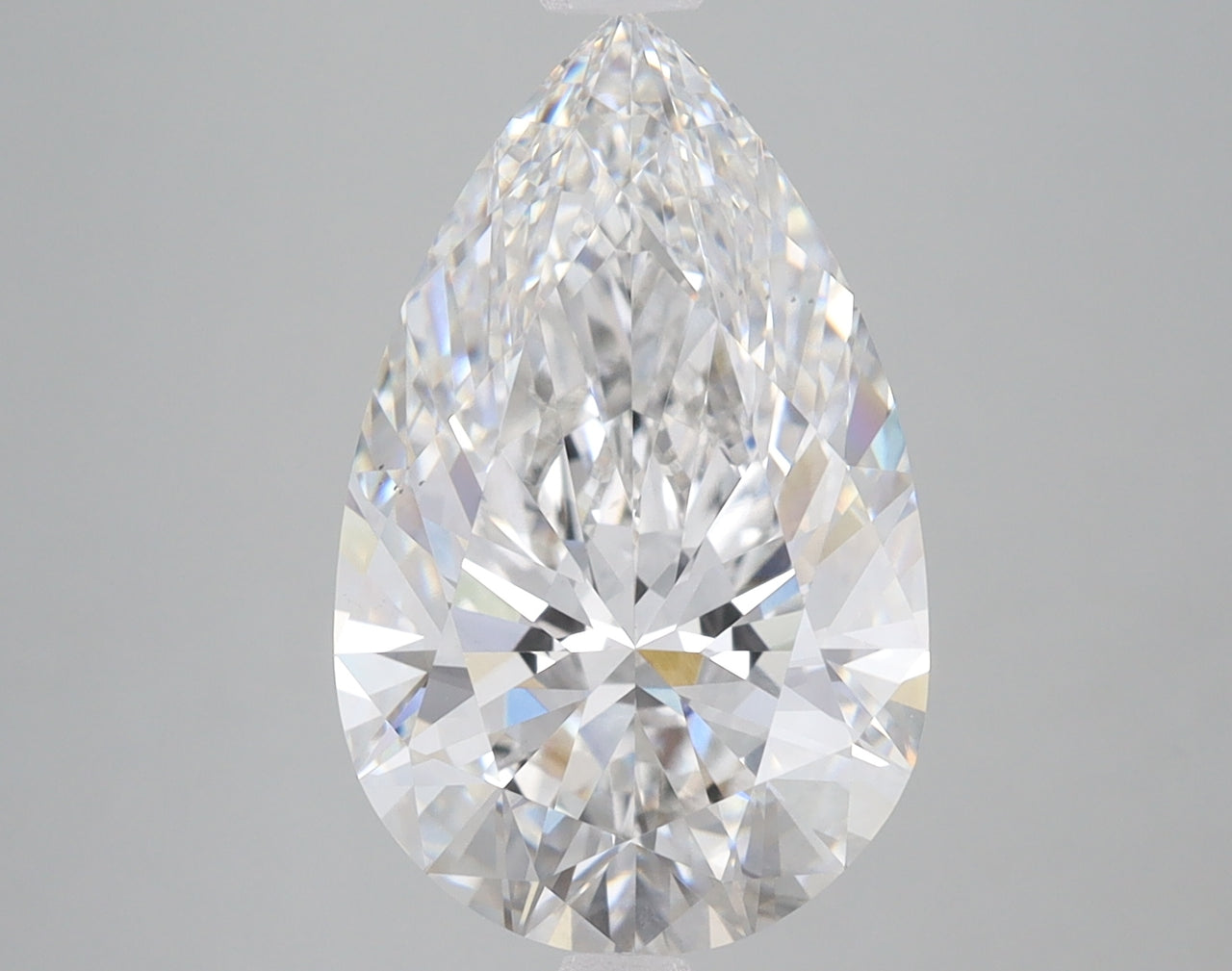 Pear-shaped lab grown diamond with faceted surfaces displaying light refraction on neutral gray background.