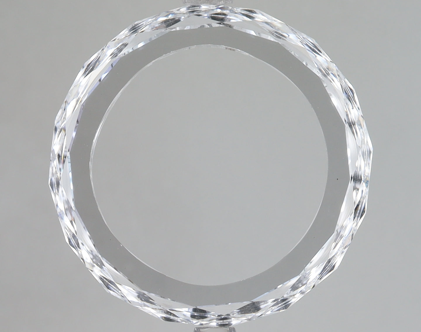 Clear, faceted lab-grown diamond loose stone with brilliant sparkle and reflective surfaces against neutral background.