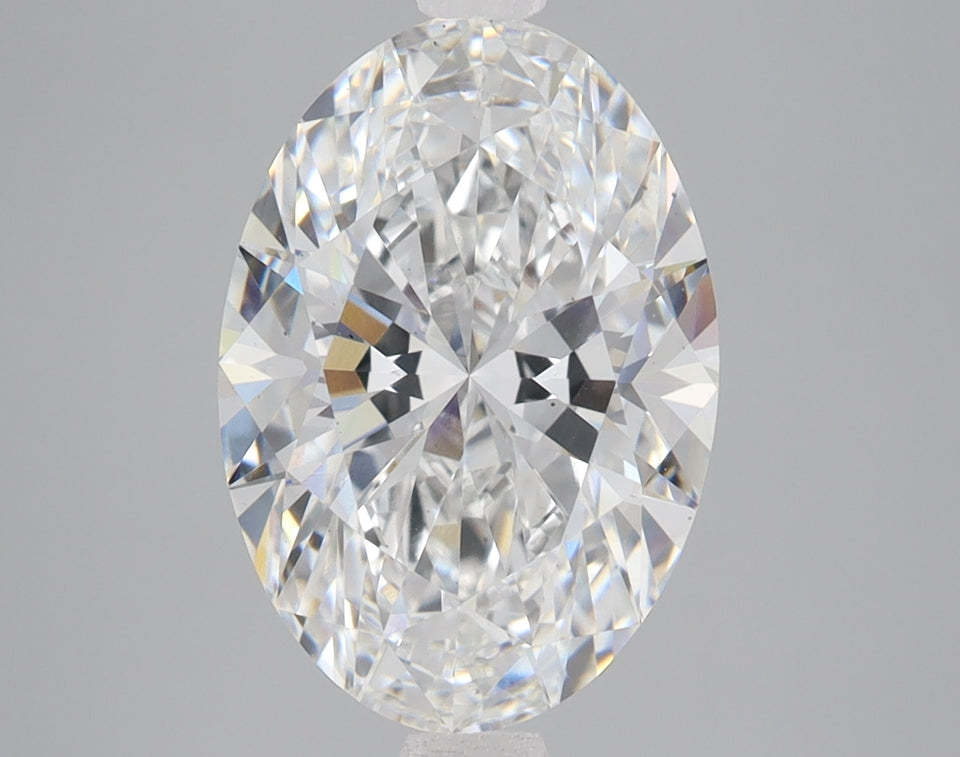 Oval-cut colorless diamond with brilliant faceting and light reflections visible throughout the stone.