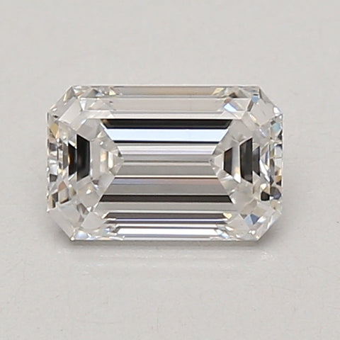 Emerald-cut colorless loose diamond with faceted surfaces and horizontal striations on gray background.