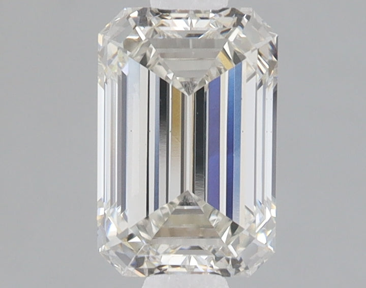 Emerald-cut lab-grown diamond with faceted sides, displaying light refraction and clarity against a neutral gray background.