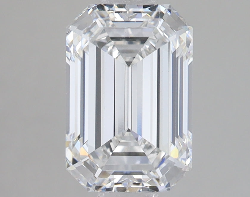 Emerald cut lab-grown diamond with faceted surface showing clear transparency and light reflection against gray background.