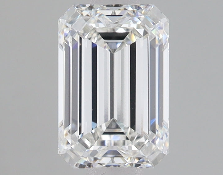 Emerald-cut lab-grown diamond with faceted surfaces and clear appearance against gray background.