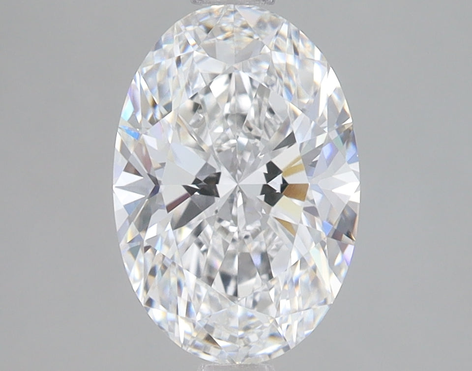 Oval-cut lab-grown diamond with faceted surface reflecting light, displayed against neutral gray background.