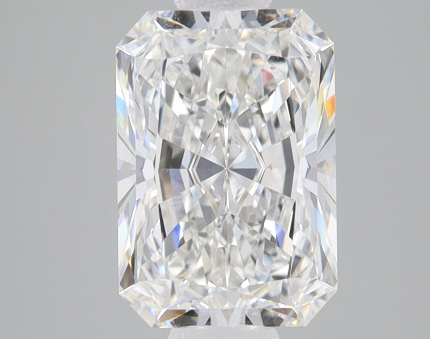 Clear radiant-cut lab-grown diamond with faceted surface and light refraction on neutral gray background.