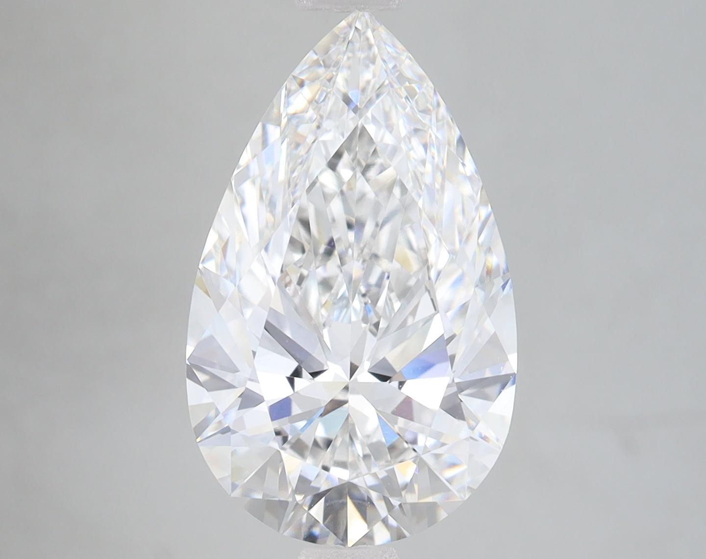 Pear-shaped clear lab-grown diamond with faceted surfaces and light reflections on neutral background.