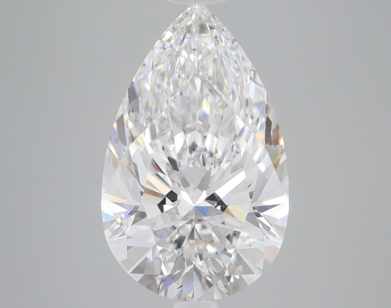 Pear-shaped clear lab-grown diamond with faceted cut and light refraction against gray background.