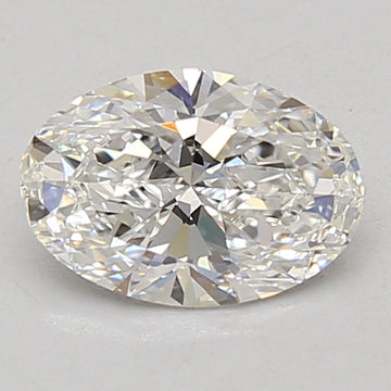 Oval-cut lab-grown diamond with faceted surface displaying white and pale yellow light reflections against a gray background.
