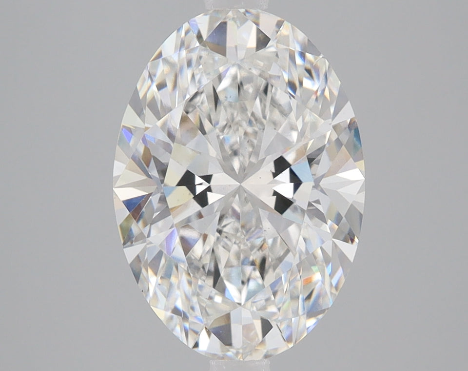 Oval-cut lab-grown diamond with faceted surface and light refraction, displayed against gray background.