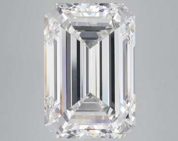 Emerald-cut lab-grown diamond with clear faceting and light reflection on neutral gray background.