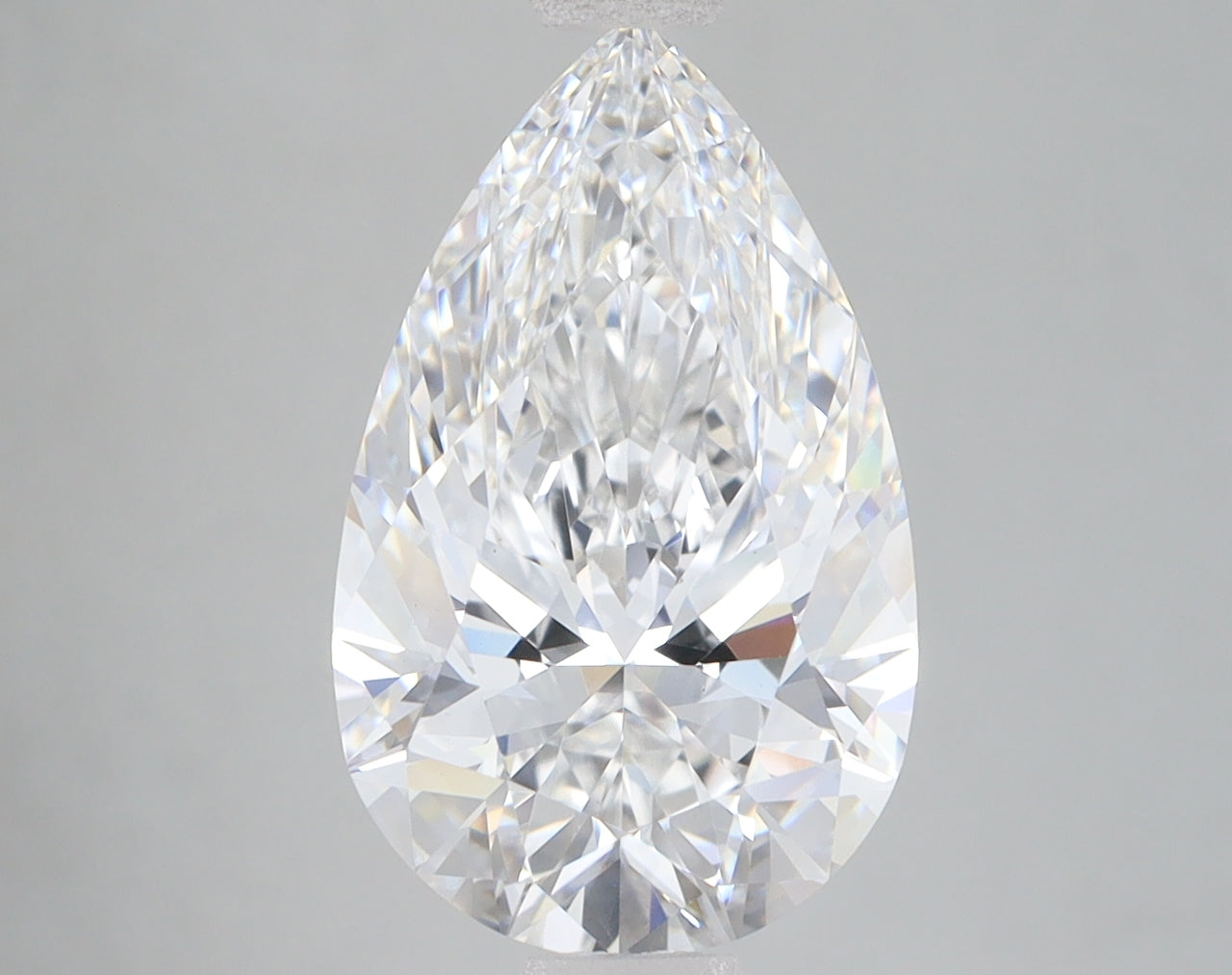Pear-shaped colorless lab-grown diamond with faceted surface and light reflections on neutral gray background.