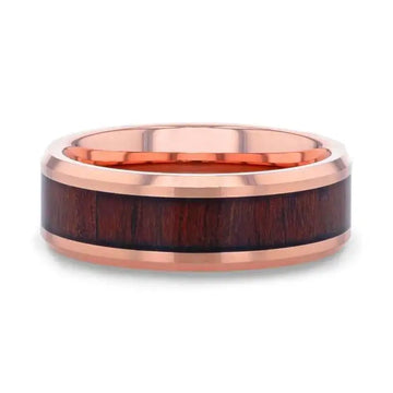 Flat lay of rose gold plated tungsten wedding band showing full koa wood inlay and polished bevels