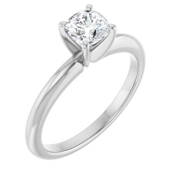 White metal solitaire engagement ring with cushion-cut diamond in four-prong setting.