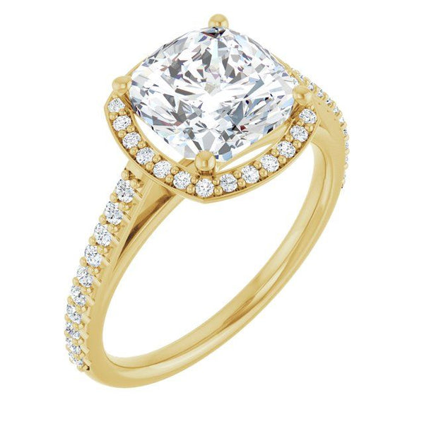 Gold four-prong halo engagement ring with cushion-cut lab diamond center and pavé diamond band.