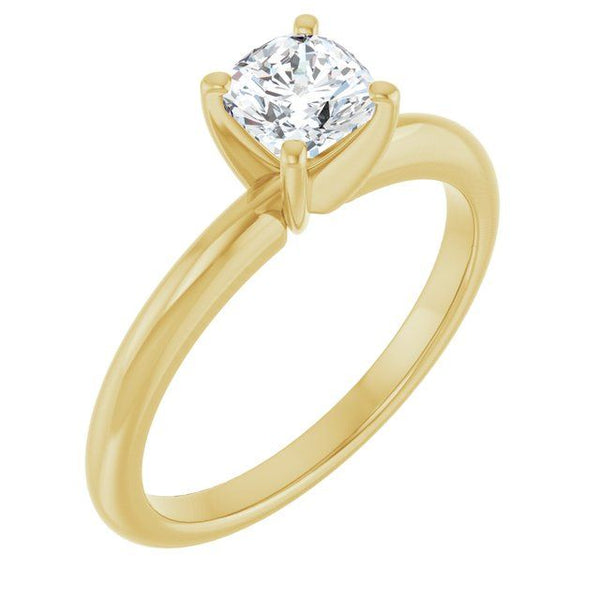 Gold solitaire engagement ring with cushion-cut diamond in four-prong setting.