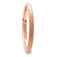 Side profile of a thin 2mm domed rose gold plated tungsten carbide ring with sandblasted crystalline texture
