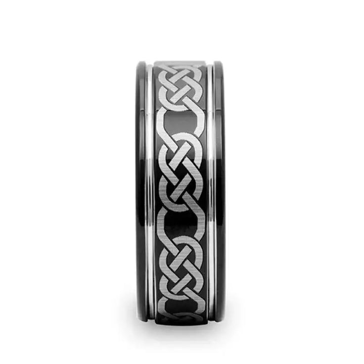 Front view showing the continuous laser-engraved Celtic knot band on a black tungsten carbide ring, 8mm width