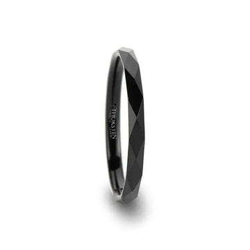 Side view of a 2mm women’s black tungsten carbide ring with diamond-faceted pattern and polished interior