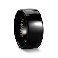 Black domed tungsten wedding band with glossy finish, side angle view showing 'THORSTEN' interior logo
