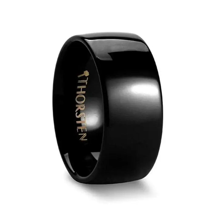 Black domed tungsten wedding band with glossy finish, side angle view showing 'THORSTEN' interior logo