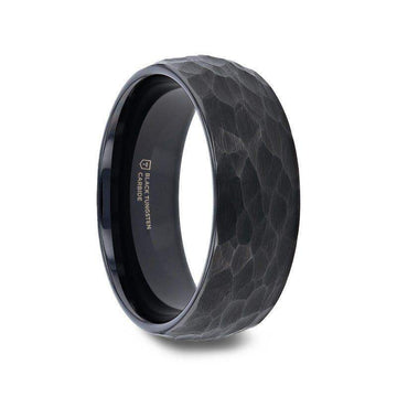 Angled view of the RENEGADE domed hammered black tungsten carbide wedding band showing the textured brushed exterior and polished black interior