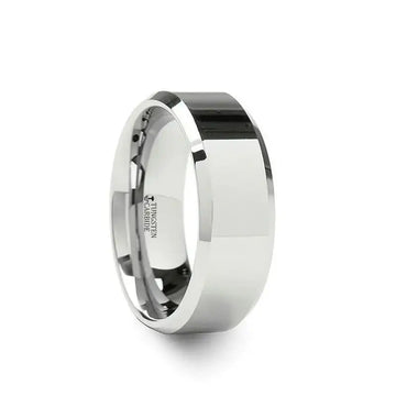 Angled view of a wider white tungsten carbide band with beveled edges and mirror polish